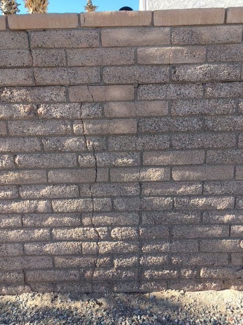 Water exposure causing cracks to brick wall.